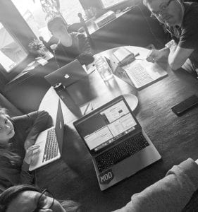 Family working on computers at dining table